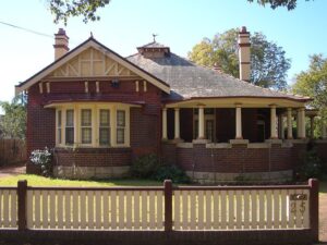 External, unobscured facade shot of a heritage federation house during a sunny day. 